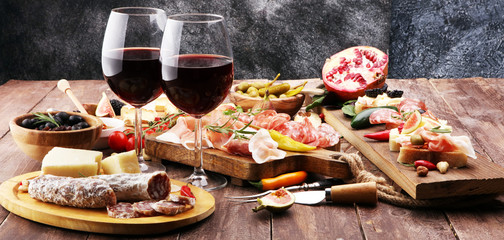 Italian antipasti wine snacks set. Cheese variety, Mediterranean olives, pickles, Prosciutto di Parma and salami