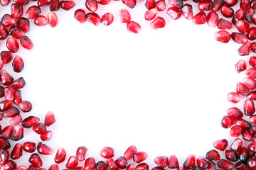 Pomegranate grain on white background . Pomegranate frame. Fruits of Red Ripe Pomegranate on the White Background. Vegetarian Concept, Organic Vitamins. Organic and Benefit Garnet Fruit.  