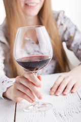 Beautiful young woman drinking red wine