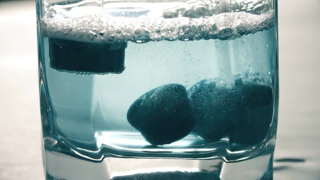 close up on cleaning the limestone from the filters in a glass