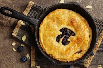 Pi Day special homemade blueberry pie baked in a skillet overhead view - obrazy, fototapety, plakaty