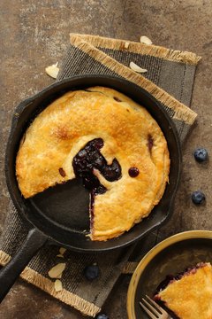 Homemade Skillet baked Blueberry pie sliced / Pi day Food