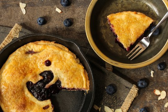Homemade Skillet baked Blueberry pie sliced / Pi day Food