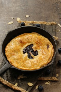 Homemade Skillet  Blueberry Pie with cut out Pi  day writing top down view