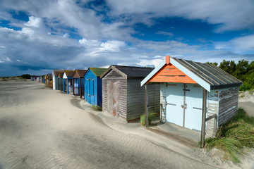 Fototapeta na wymiar Beach Huts on a Sandy Beach