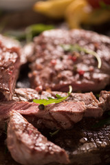 grilled meat with herbs on wooden board