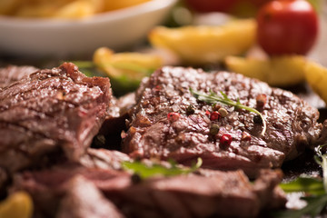 grilled meat with herbs on wooden board
