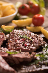 grilled meat with herbs on wooden board