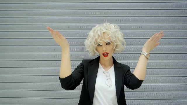 Young fashion girl is tired and feeling heat. She is flapping hands for her face and body and breathing