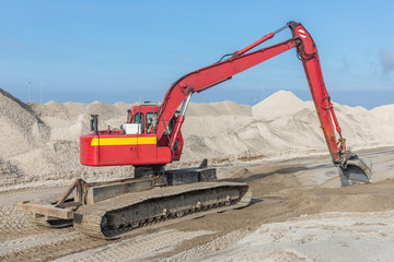 Excavator at construction site for building a new harbor near lelystad in The Netherlands