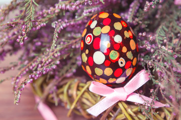colorful Easter egg in the heather bouquet,