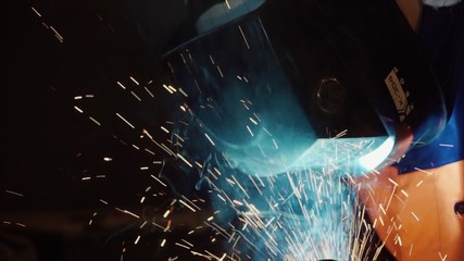 Welder at work in metal industry. Clip. Welder at work in factory. Welder welding a metal in workshop