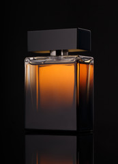 perfume bottle over black background