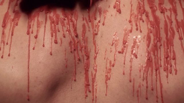 Dripping wax on a male body