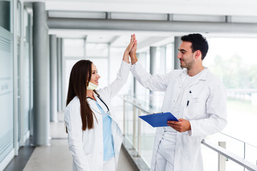 Doctors high five after successful surgery