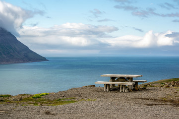 A wooden bench on a hill with beautiful outlook in Iceland
