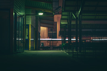 Central marketplace at night time. Isolated territory filled with trading stands and lighten by city lights. Spooky and abandoned atmosphere in urban market territory. 