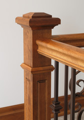 victorian style staircase wood newel post haindrail brown metal baluster close-up