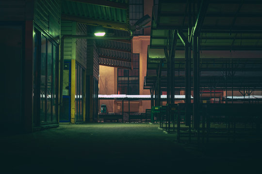 Central marketplace at night time. Isolated territory filled with trading stands and lighten by city lights. Spooky and abandoned atmosphere in urban market territory. 