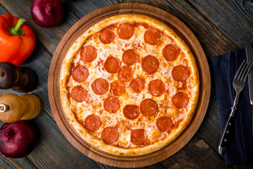 Pepperoni pizza on plate - obrazy, fototapety, plakaty