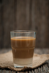 Classic still life a glass of coffee with copy space, vertical vintage picture.