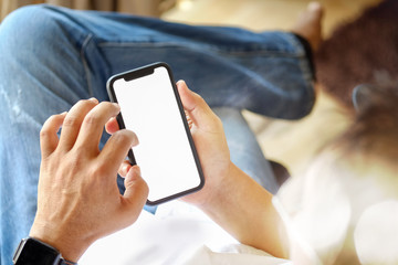 Mobile phone in man's hand, Smartphone showing blank screen for graphic display montage.