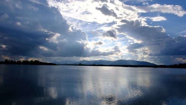 The lake has a reflection of the clouds and the sky. 