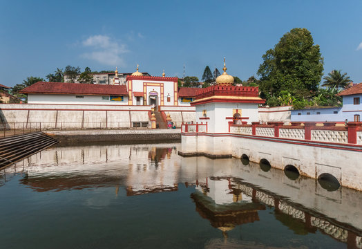 Madikeri, India - October 31, 2013: Wide shot of Shree Omkareshwara Temple in combination with the shrine set in tank, under blue sky.