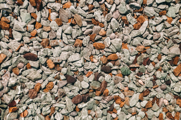 texture and background. pebbles. glare of water. sea water.