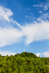 Beautiful landscape of hills and hills in summer, trees green, blue sky and white clouds