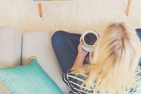 Happy Young Woman Drinking Coffee At Home