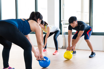 coach showing how to workout with kettlebell