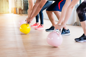 view of fitness learning holding kettlebell