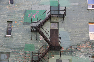 Fire stair at a green brick wall building