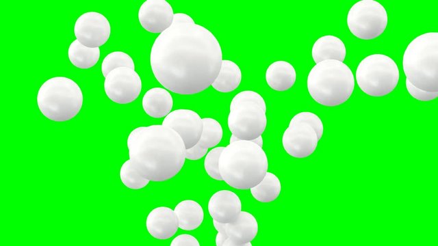 Animated plain white ping pong balls exploding and flying toward camera in slow motion and against green background.