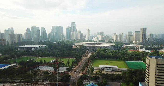 Beautiful aerial footage of Jakarta city with view of Gelora Bung Karno Main Stadium and skyscraper in the morning. Shot in 4k resolution