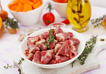 Ingredients for cooking chicken hearts with pumpkin and tomatoes in tomato sauce. The garnish is served with boiled rice.