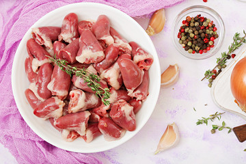 Ingredients for cooking chicken hearts with pumpkin and tomatoes in tomato sauce. The garnish is served with boiled rice. Flat lay. Top view.