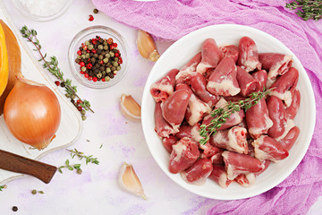 Ingredients for cooking chicken hearts with pumpkin and tomatoes in tomato sauce. The garnish is served with boiled rice. Flat lay. Top view.