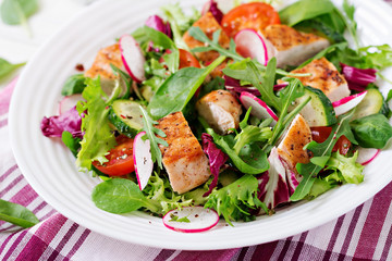 Fresh vegetable salad with grilled chicken breast   - tomatoes, cucumbers, radish and mix lettuce leaves. Chicken salad. Healthy food.