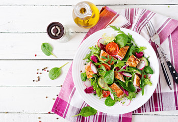 Fresh vegetable salad with grilled chicken breast   - tomatoes, cucumbers, radish and mix lettuce leaves. Chicken salad. Healthy food. Top view