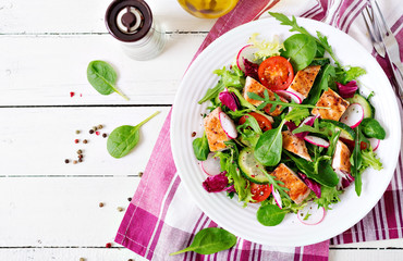 Fresh vegetable salad with grilled chicken breast   - tomatoes, cucumbers, radish and mix lettuce leaves. Chicken salad. Healthy food. Top view