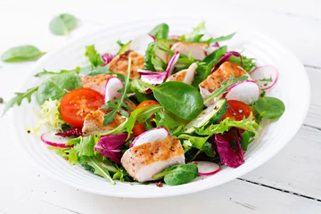  Fresh vegetable salad with grilled chicken breast   - tomatoes, cucumbers, radish and mix lettuce leaves. Chicken salad. Healthy food. © timolina