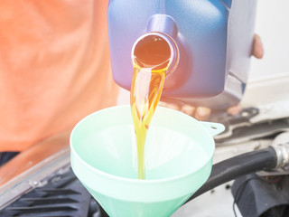 Mechanic change engine oil to preserve engine life,  maintenance concept