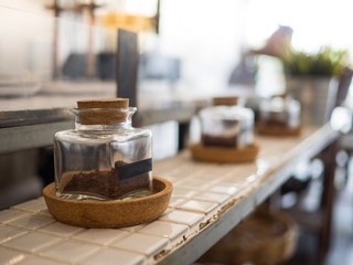 Coffee powder in bottle on table
