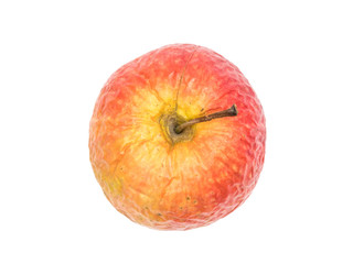 Old wrinkled apple isolated on white background seen from above