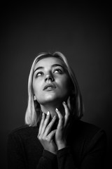 Fototapeta premium young blond female is posing in the studio. black and white