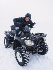 Man in atv quad bike. Winter snow field © paulzhuk