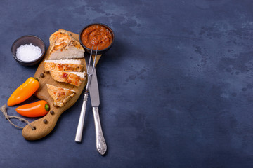 Sliced cooked fillet chicken and sauce