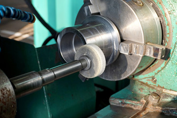 Spindle with an abrasive circle for intra grinding work on the grinder. Dry grinding by a circle end face by a long frame and thin white stone. There grinding inner sleeve hole.